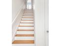 Elegant staircase with wooden steps and white risers, leading to the upper level of the home at 645 N Ritter Ave, Indianapolis, IN 46219