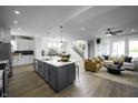 Open-concept kitchen featuring a large island, stainless steel appliances, and hardwood floors at 781 Rose Garden Way, Westfield, IN 46074