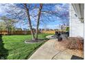 Expansive backyard with a well-maintained lawn, a patio, and a privacy fence at 8107 Parcrest Ct, Indianapolis, IN 46259