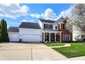 Inviting two-story home with a brick facade, attached two-car garage, and beautiful curb appeal at 8107 Parcrest Ct, Indianapolis, IN 46259