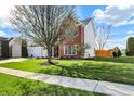 Well-maintained front yard with a lush lawn and mature trees, leading to a charming home at 8107 Parcrest Ct, Indianapolis, IN 46259
