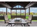 Comfortable outdoor seating area with a beautiful view of the backyard and pond at 8650 N Springview Dr, McCordsville, IN 46055