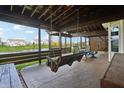 Relaxing covered porch with a swing, perfect for enjoying the views of the pond at 8650 N Springview Dr, McCordsville, IN 46055