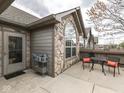 Stone-accented exterior with a patio area, complete with seating and a convenient access door at 871 Gazebo Way, Greenwood, IN 46142