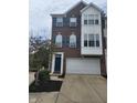 Charming brick townhouse with blue shutters and a two-car garage at 9454 Tanhurst Dr, Indianapolis, IN 46250