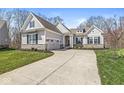 Charming single-Gathering home showcasing professional landscaping, a stone foundation, and inviting curb appeal at 11172 Cliffside Dr, Fortville, IN 46040
