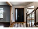 Inviting entryway with wood floors, decorative rug, and a staircase leading to the upper level of the home at 1228 Knapps Ct, Greenwood, IN 46142
