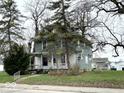 Charming two-story home with a covered front porch and mature trees in a residential neighborhood at 1325 S Hackley St, Muncie, IN 47302