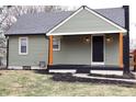 Charming home featuring an inviting covered porch with wooden accents at 150 E Troy Ave, Indianapolis, IN 46225