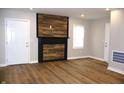Modern living room with stylish wood accent wall and hardwood floors at 150 E Troy Ave, Indianapolis, IN 46225