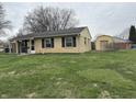 Quaint single-story home with large front lawn and detached garage at 1502 Saint John S Ct, Beech Grove, IN 46107