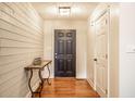 Inviting entryway with hardwood floors and painted paneled walls at 1550 Renee Dr, Plainfield, IN 46168
