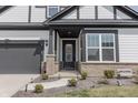 Welcoming home with a decorated front door, brick accents, manicured landscaping, and stone walkway at 15755 Scher Dr, Westfield, IN 46074