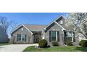 Lovely home featuring brick exterior, manicured lawn, tidy landscaping, and a clean, inviting curb appeal at 1630 Valdarno Dr, Greenwood, IN 46143