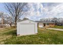 View of detached garage and driveway of home with lawn at 1700 N Tibbs Ave, Indianapolis, IN 46222
