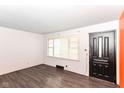 Bright living room features wood-look floors, a large window, and freshly painted walls at 1700 N Tibbs Ave, Indianapolis, IN 46222