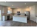 Spacious kitchen with white cabinets, stainless steel appliances, and large island at 240 Ames Dr, Whiteland, IN 46184
