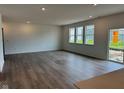 Open living room with hardwood floors, recessed lighting, and a sliding glass door at 240 Ames Dr, Whiteland, IN 46184
