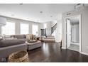 Bright living room with dark hardwood floors, neutral walls, and comfortable seating arrangement near the staircase at 2618 Congress St, Carmel, IN 46032
