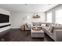 Inviting living room featuring a large sectional sofa, dark hardwood floors and contemporary decor at 2618 Congress St, Carmel, IN 46032