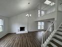 Spacious living room with brick fireplace, high ceilings, and wood floors at 3734 Ontario Cir, Indianapolis, IN 46268