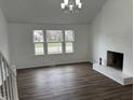 Cozy living room featuring a brick fireplace and large windows at 3734 Ontario Cir, Indianapolis, IN 46268