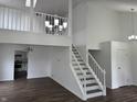 Bright, open living room with wood floors and staircase to second level at 3734 Ontario Cir, Indianapolis, IN 46268
