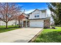 Charming two-story home boasts brick and white siding, attached two-car garage and well-manicured lawn at 4345 Elkhorn Dr, Westfield, IN 46062