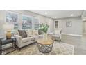 Bright living room with neutral tones, large windows, and stylish furnishings at 4601 N Ball Ave, Muncie, IN 47304