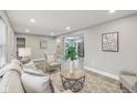 Inviting living room featuring modern decor, wood floors, and ample natural light at 4601 N Ball Ave, Muncie, IN 47304