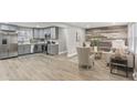 Open concept living space with updated kitchen, stainless steel appliances, and hardwood floors at 4601 N Ball Ave, Muncie, IN 47304