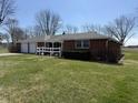Lovely front exterior of a brick home with a lush green lawn and driveway leading to the garage at 4611 E Us Highway 36, Markleville, IN 46056