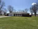 Charming front exterior of a brick home with attached garage and well-maintained lawn at 4611 E Us Highway 36, Markleville, IN 46056
