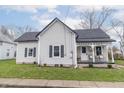 Quaint single-Gathering home showcasing black shutters, a front porch, and mature landscaping at 508 Mount St, Greenfield, IN 46140