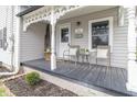 Inviting front porch with seating, plants, and decorative trim on a charming home at 508 Mount St, Greenfield, IN 46140
