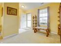 Bright entryway with neutral carpet, a decorative bench, and natural light from a window at 5417 Kerns Ln, Indianapolis, IN 46268