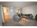 Comfortable living room with neutral carpet, modern lighting, and a large sectional sofa at 5707 W Mills Rd, Indianapolis, IN 46221