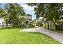 Well-manicured lawn and landscaping complement the charming exterior of this inviting two-story home at 5718 E Pleasant Run Parkway North Dr, Indianapolis, IN 46219