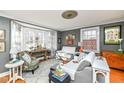 Cozy living room featuring a bay window, hardwood floors, and comfortable seating at 5718 E Pleasant Run Parkway North Dr, Indianapolis, IN 46219