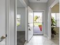 Bright and airy foyer with white tile flooring, fresh paint, and a view of the front yard at 6524 Turf Way, Anderson, IN 46013