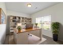 Well-lit home office with built-in bookshelves and a large window at 6524 Turf Way, Anderson, IN 46013