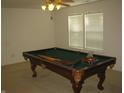 Spacious game room featuring a classic pool table and window views at 10762 Galant Fox Ct, Indianapolis, IN 46234
