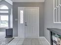 Welcoming entryway with light tile flooring, gray walls, and a bright front door at 1228 Easton Point Dr, Greenwood, IN 46142