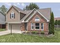 Lovely two-story home featuring brick and siding accents, an attached garage, and well-kept landscaping at 1228 Easton Point Dr, Greenwood, IN 46142
