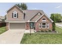 Beautiful two-story home with brick and siding, an attached garage, and a green lawn at 1228 Easton Point Dr, Greenwood, IN 46142