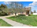 Well-manicured front yard with mature trees and a charming brick home with sidewalk entry at 12404 Rose Haven Dr, Indianapolis, IN 46235