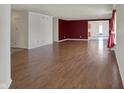 Bright living room with hardwood floors and open layout leading to the dining area and kitchen at 12404 Rose Haven Dr, Indianapolis, IN 46235