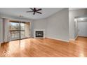 Spacious living room with wood floors, fireplace, and sliding glass door to balcony at 12570 Timber Creek Dr # 7, Carmel, IN 46032