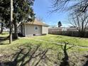 View of the backyard space with a fence and partial view of the home's exterior at 1302 Lindley Ave, Indianapolis, IN 46241
