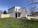 Side view of a well-maintained home with vinyl siding and a fenced yard at 1404 Alonzo Pl, Indianapolis, IN 46217